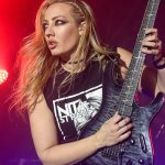 “Watching her on the biggest stage in the world, with the biggest star in the world, blazing solos faster than anybody that I’d ever seen”: Nita Strauss on the guitarist that inspired her to pursue a career in music