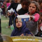 Palestinians lined up for hours for food by a charity kitchen in central Gaza.
