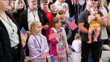 First group of white South Africans arrive US as Trump claims they face discrimination