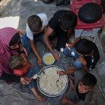 Desperate Palestinians queue for food at soup kitchen during Eid al-Adha