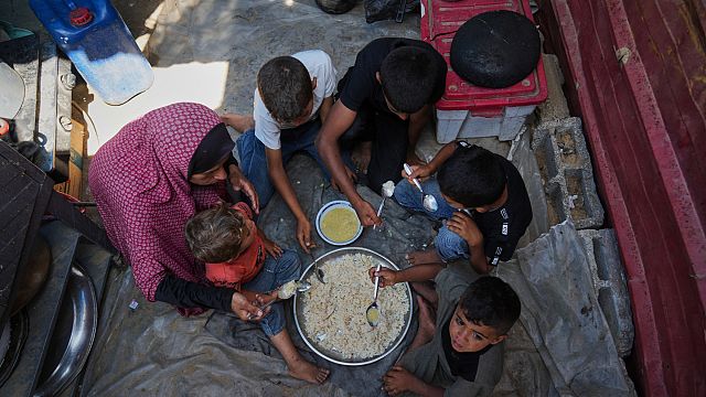 Desperate Palestinians queue for food at soup kitchen during Eid al-Adha