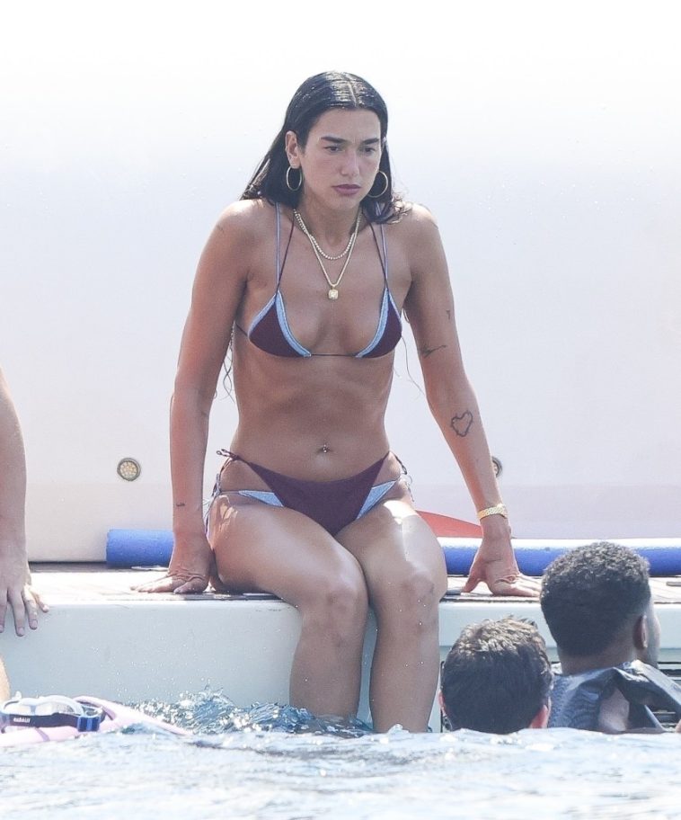 Bikini-clad Dua Lipa flaunts shredded abs during paddleboard yoga in Ibiza