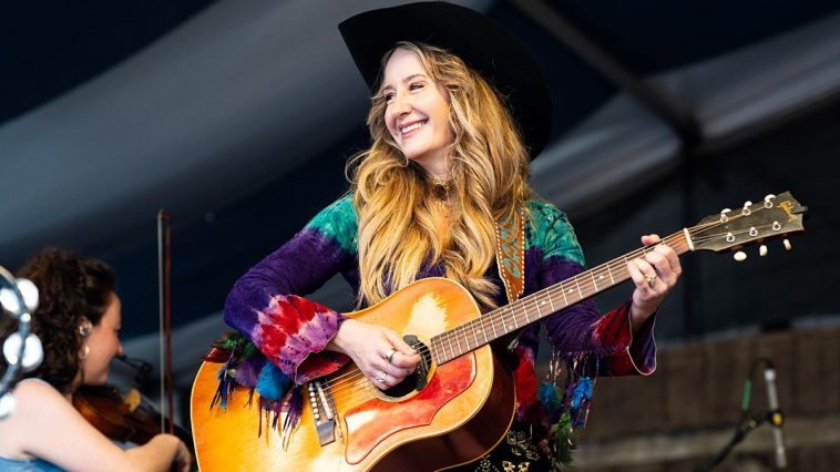 “He has this really old black acoustic that everybody has signed. It’s got Johnny Cash’s name scratched into it, and he had me sign it”: How a rite of passage led Margo Price to etching her signature onto a guitar next to a country legend’s