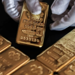 Gold futures slip, set for weekly gains